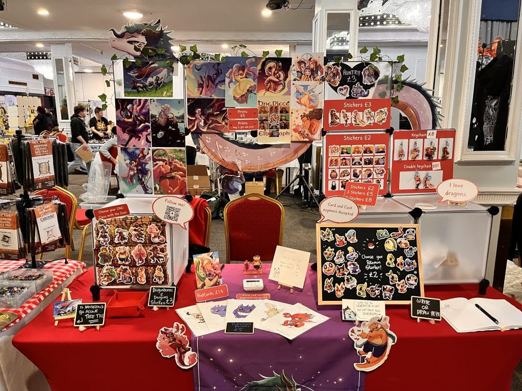 A table with a display with stickers, prints, decorated with a dragon.